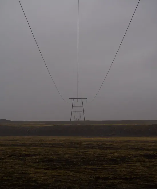 Powerlines extending off into the foggy distance