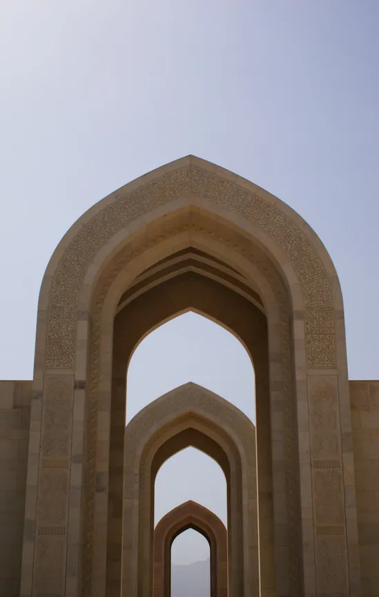 Three aligned arches marking an exit from the Grand Mosque