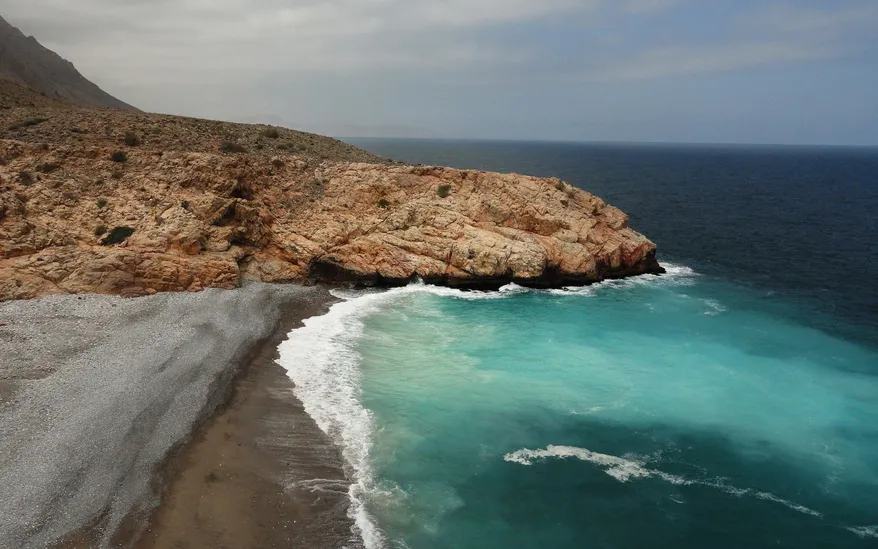 A protected cove formed by a rocky outcrop